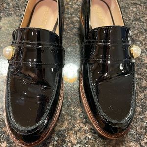 Stuart Weitzman patent leather loafer with pearl detailing.